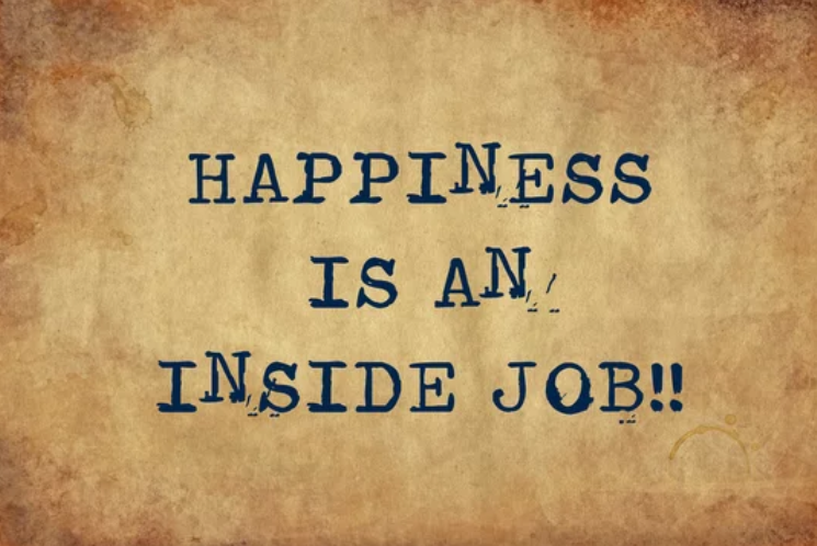 Inspirational quote "Happiness is an inside job" in vintage typewriter font.