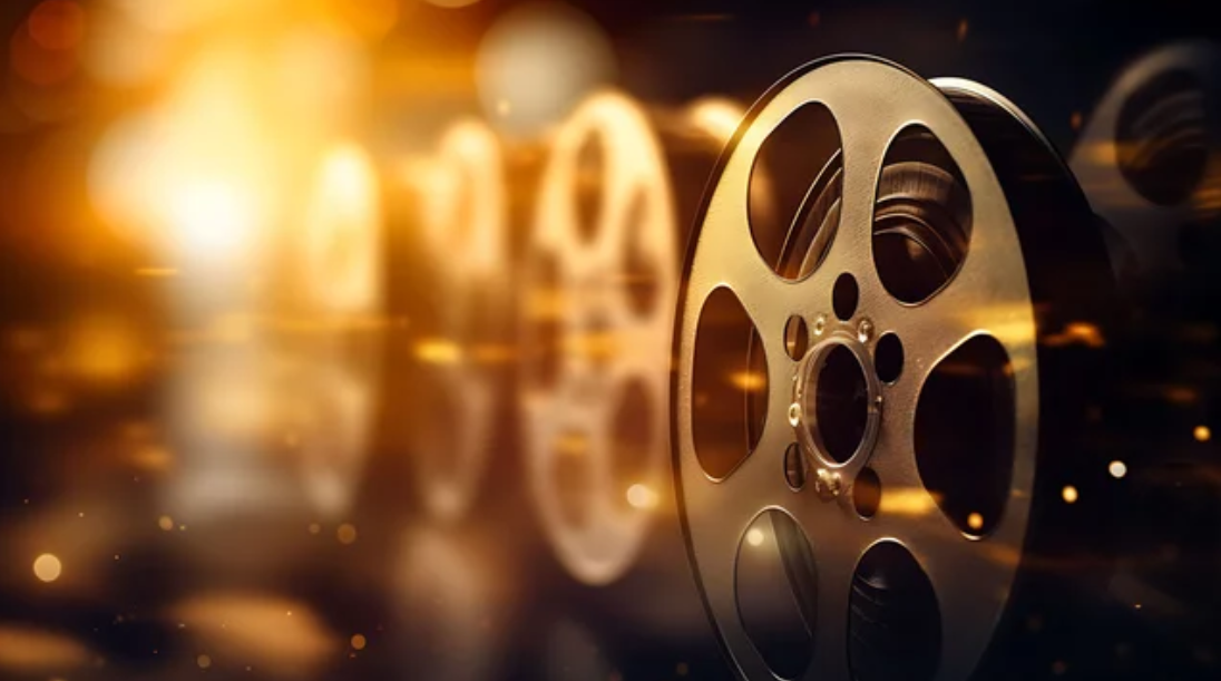 Golden film reels in warm glowing light, symbolizing the timeless allure and artistry of cinema